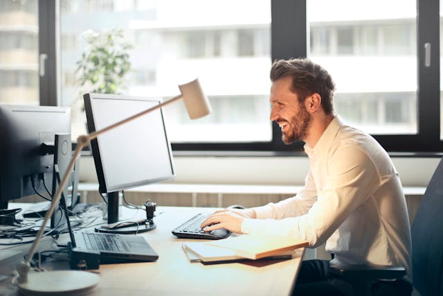 A property manager sitting at their desk looking at a computer